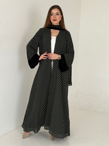 Woman wearing a black and white patterned outfit on a white background